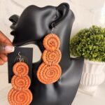 OLAEDO orange Raffia Triple disc earrings